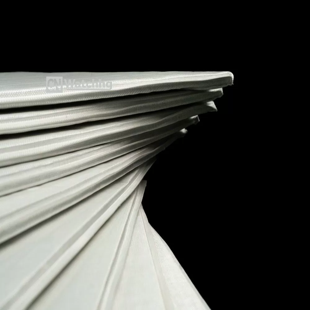Close-up view of the proprietary edge-sealing technology and high-barrier multi-layer film on Woqin's fumed silica Vacuum Insulation Panels, ensuring 20-year vacuum stability.